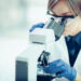 Lab technician with microscope.
